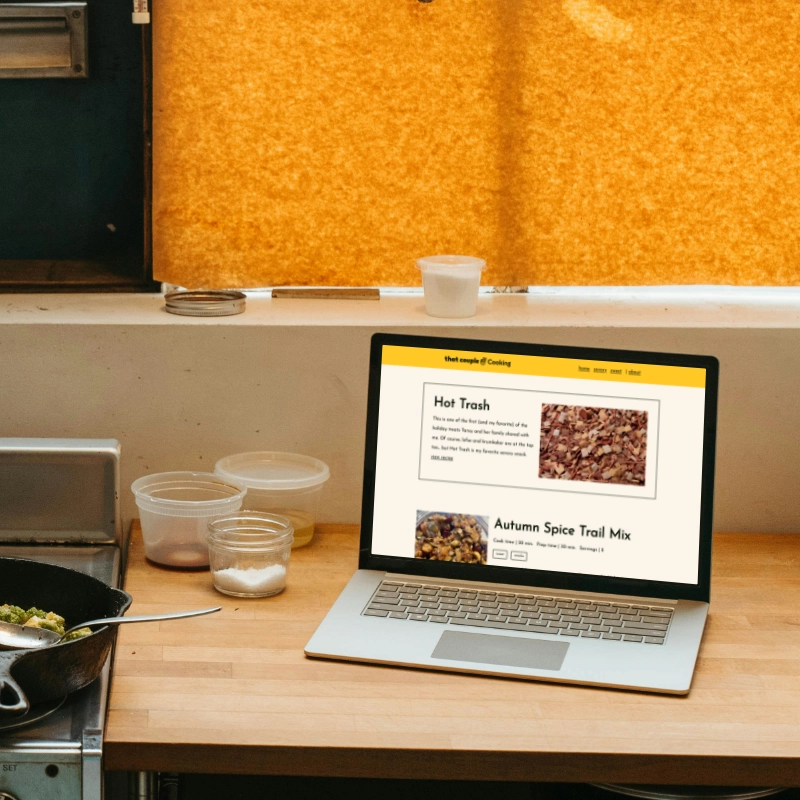 laptop on kitchen counter displaying That Couple Cooking website